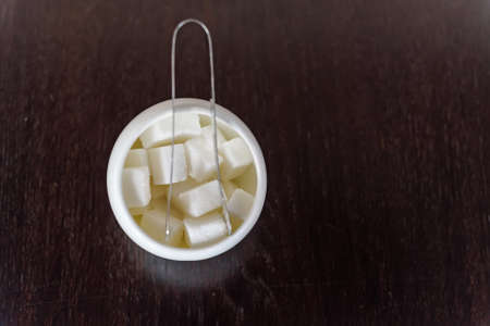 Sugar cubes in sugar bowl and sugar tongsの写真素材