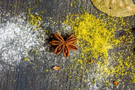 Star anise, curry and flour on wooden backgroundの写真素材
