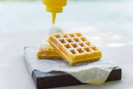 Syrup put on belgian wafflesの写真素材