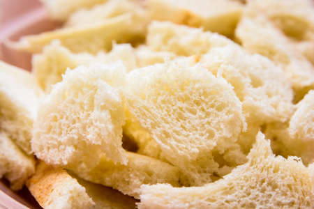 Close up pieces of bread in bowlの写真素材