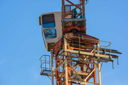 Close up construction crane builds new buildingの写真素材
