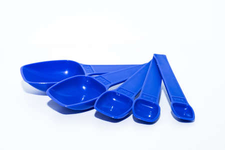 Blue measuring spoons isolated on white