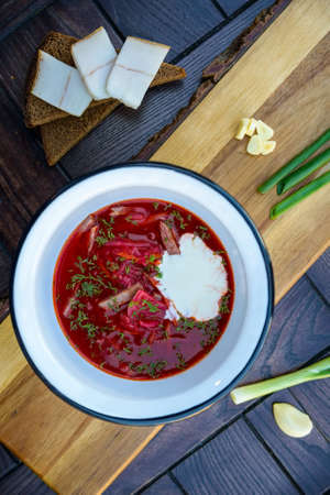 Ukrainian borsch soup and green onion on the tableの写真素材