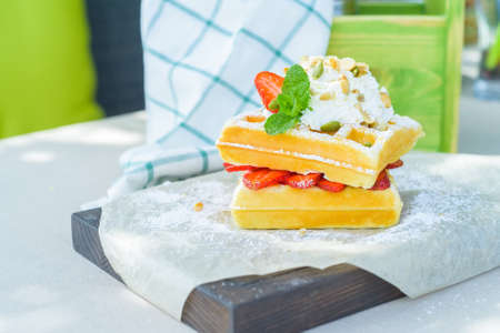 Belgian waffles with strawberry in restaurantの写真素材