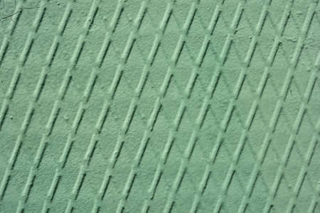 Linear pattern on old wall painted greenの写真素材