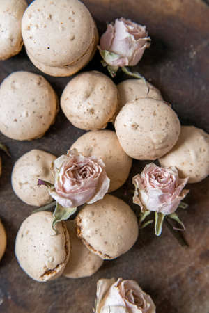 Beige macarons and dry roses vintage backgroundの写真素材