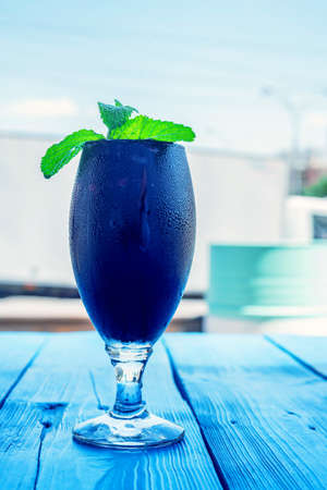 Dark restaurant cocktail with mint and raspberryの写真素材