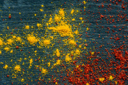 Paprika powder and turmeric on wooden backgroundの写真素材