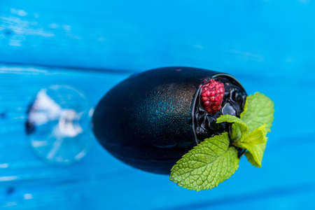 Dark restaurant cocktail with mint and raspberryの写真素材