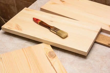 Carpenters brush on wooden plankの写真素材