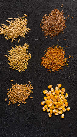 Piles of six different grains on black backgroundの写真素材