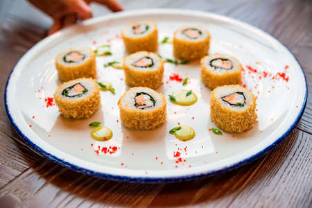 Fresh sushi rolls served on plate in restaurantの写真素材