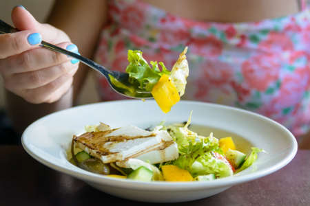 Wonam eats Greek salad in restaurant close upの写真素材