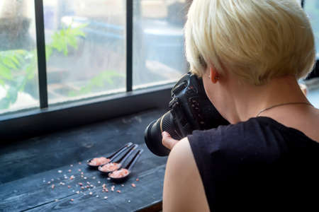 Female food photographer at work rear viewの写真素材