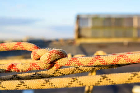 Closeup stretched and tied industrial braided rope