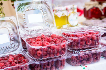 Raspberries in plastic box in supermarketの写真素材