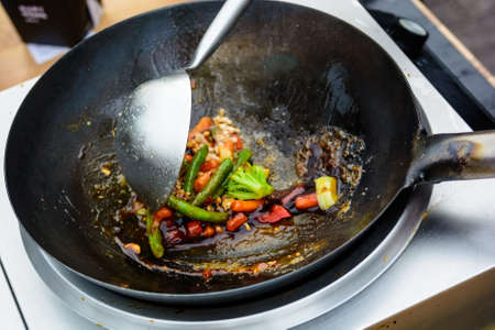 Stir fried vegetables in wok close upの写真素材