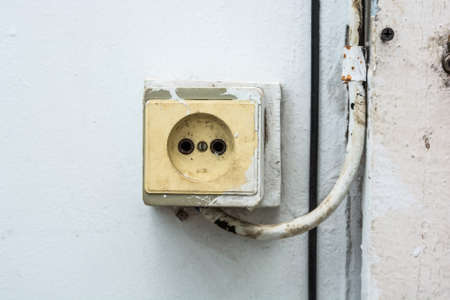 Close up old outlet on the wall