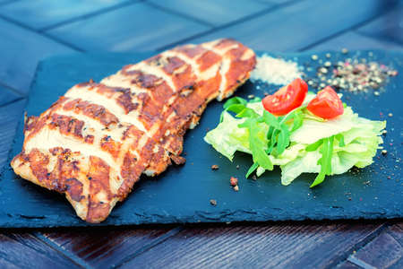 Grilled turkey fillet and vegetables in restaurantの写真素材