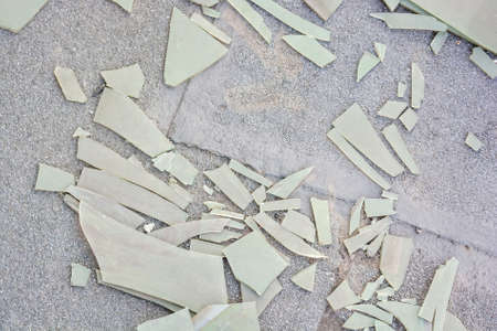 Pieces of broken plastic sheet on groundの写真素材