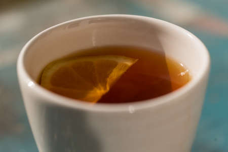 Close up white cup with tea and lemonの写真素材