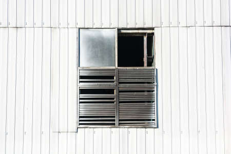 Close up window in wall of industrial buildingの写真素材