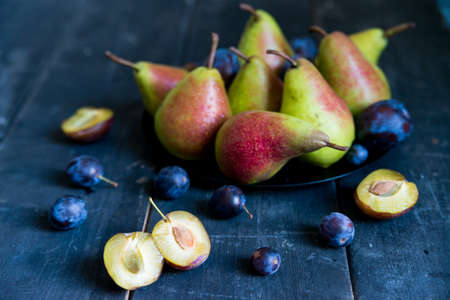 Studio shot plums and pears on plate heathy dietの写真素材