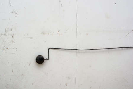 Old black fire alarm detector on white wallの写真素材