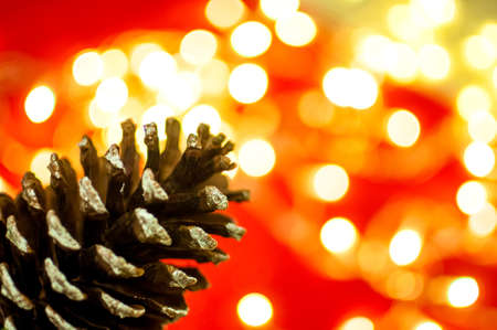 Christmas background with cone and blurred lightsの写真素材