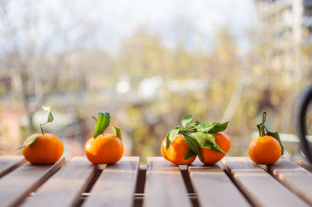 Fresh tangerines on wooden surface outdoorsの写真素材