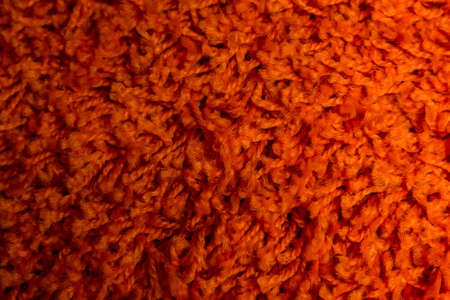 Close up of bright red domestic woolen carpet textureの写真素材