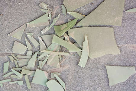 Pieces of broken plastic sheet on groundの写真素材