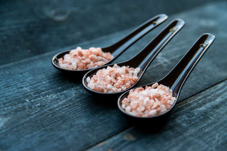 Studio shot of three spoons of pink himalayan salt