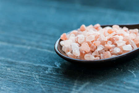 Studio shot of spoon with rough pink saltの写真素材