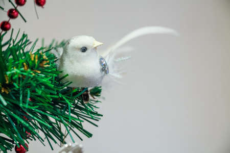 Close up Christmas toy of white bird on treeの写真素材