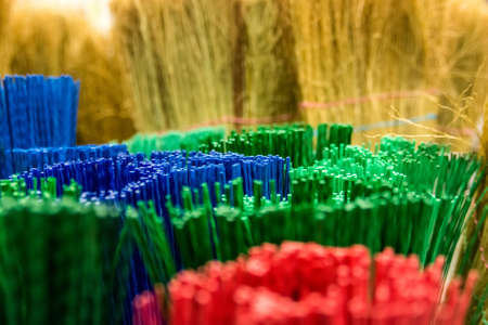Close up colorful brooms in marketの写真素材