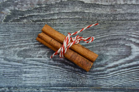 Bunch of cinnamon sticks on wood Christmas conceptの写真素材