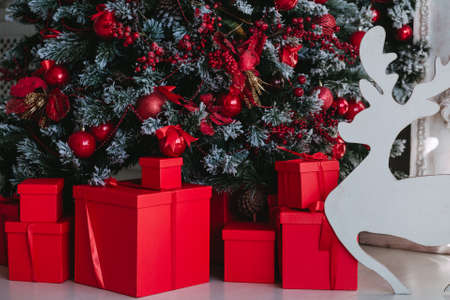 Red Christmas gifts under a christmas treeの写真素材