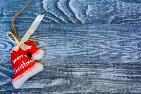 Small red Christmas decoration on wooden surfaceの写真素材