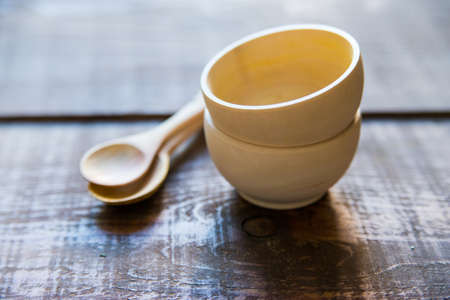 Close up empty kitchen utensils made of wood on dark wooden tableの写真素材