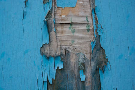 Blue cracked painting on wooden surface