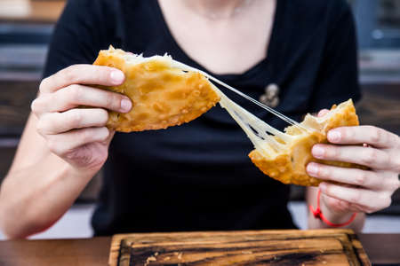 Eating traditional Georgian bread khachapuriの写真素材
