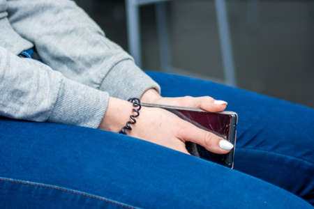 Close up womans hands hold smartphoneの写真素材
