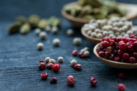 Close up three wooden spoons with colorful spices