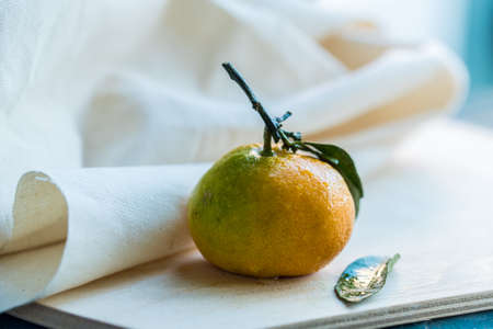 Close up fresh tangerine with leaf on whiteの写真素材