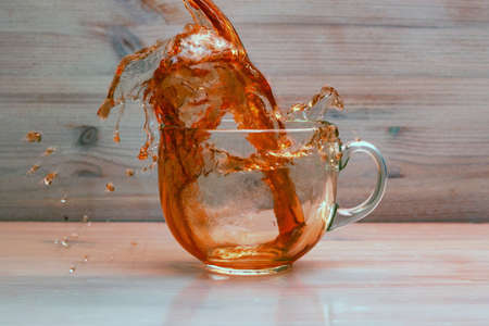 Puring tea in transparent cupの写真素材