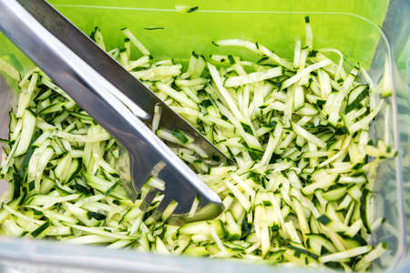 Close up chopped cucumber in plastic containerの写真素材