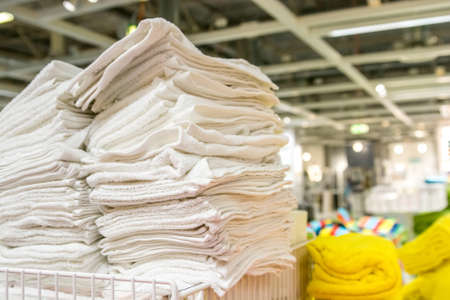 Closeup of colorful towels lying on shelf in storeの写真素材