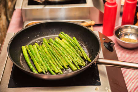Preparing green asparagus in frying panの写真素材