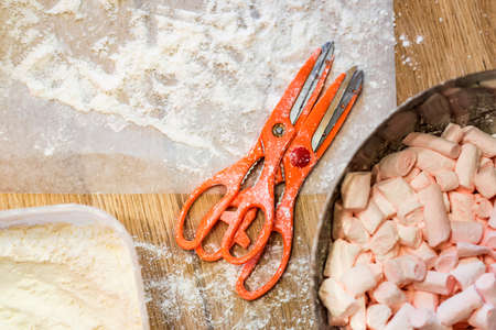 Table with scissors and white marshmallowの写真素材